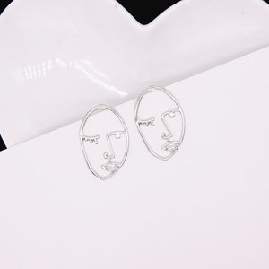 Abstract Stylish Hollow Out Face Dangle Earrings